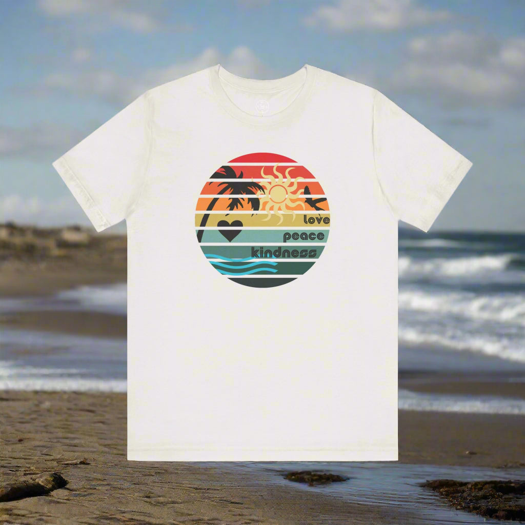 White t-shirt with a colorful graphic on a beach