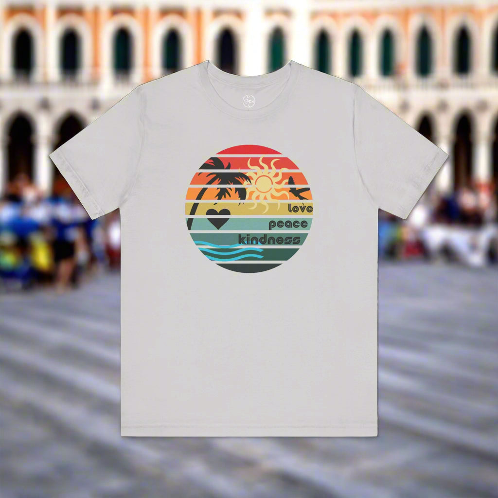 White t-shirt with a colorful graphic design in front of a blurred cityscape