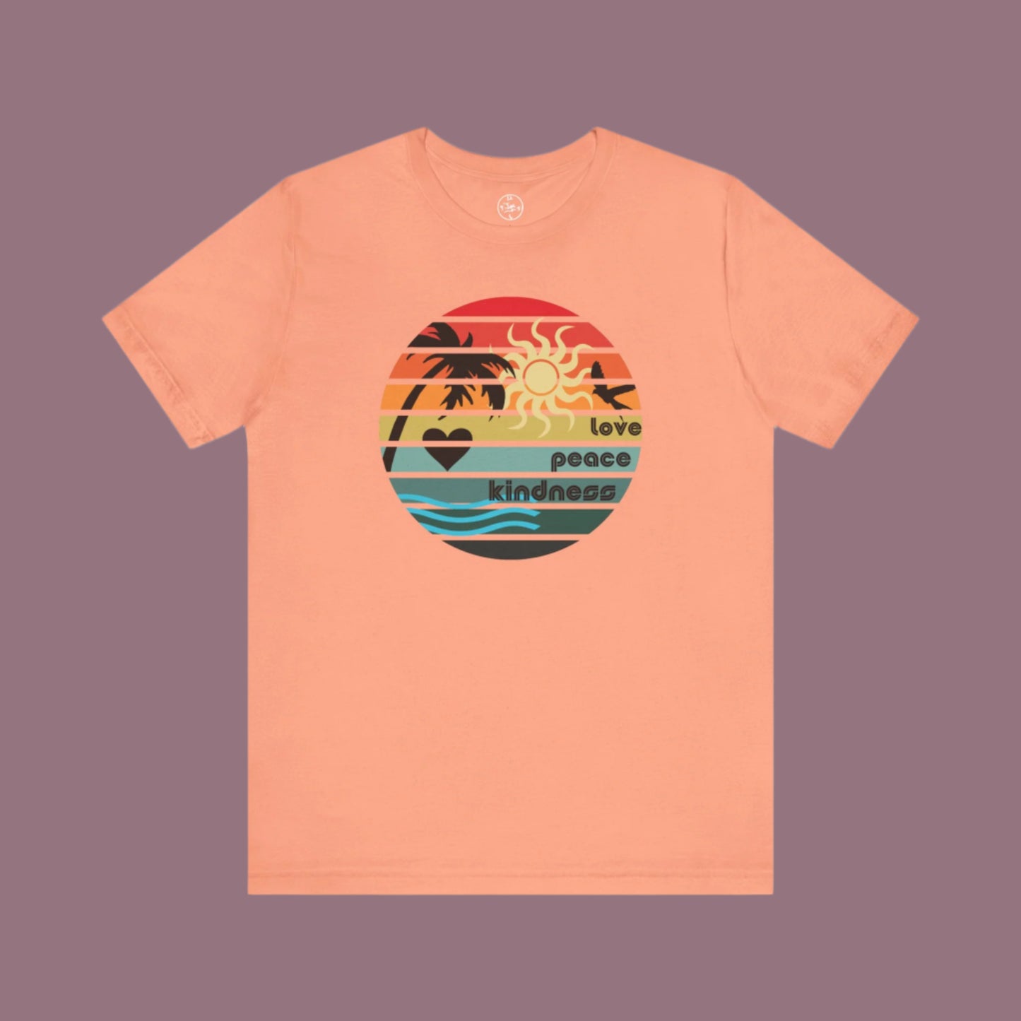 Peach-colored t-shirt with a colorful graphic design on a white background