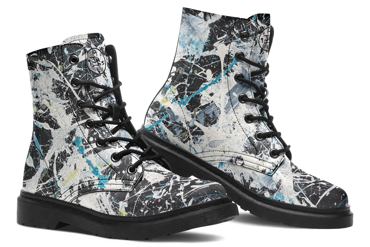 Pair of black and white splatter-patterned boots on a white background