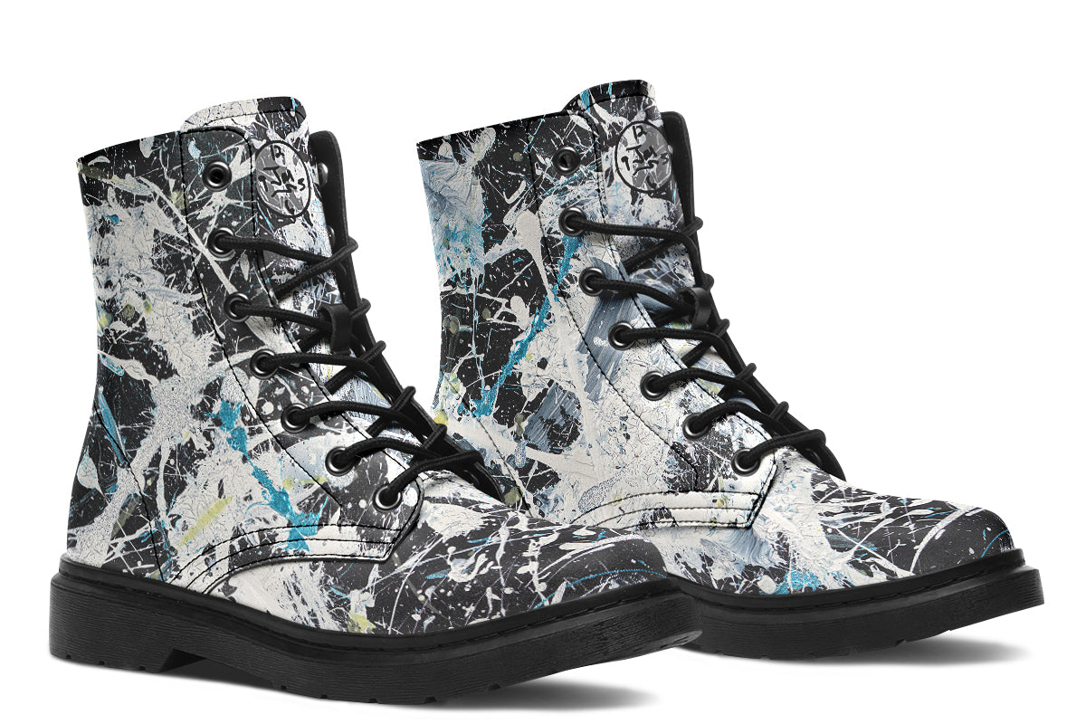 Pair of high-top boots with a black and white abstract pattern on a white background
