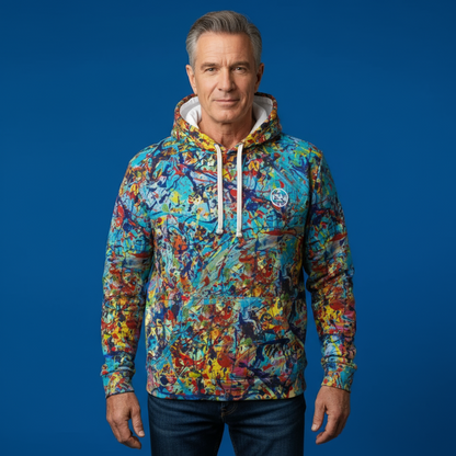 Man wearing a colorful hoodie against a blue background
