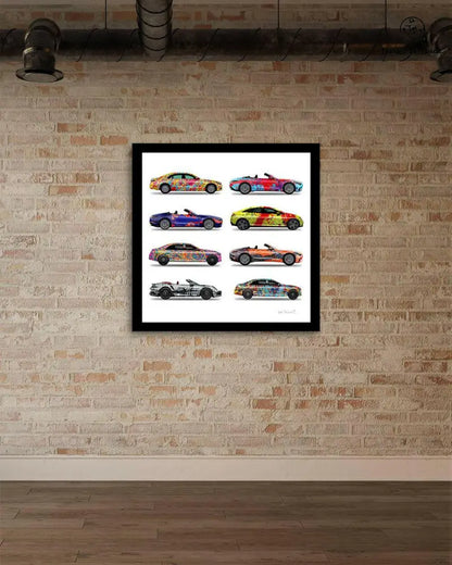 Stack of eight colorful car prints by Jumper Maybach on paper, featuring vibrant vehicle artwork and brick gallery background.
