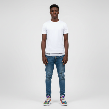 Person wearing a white t-shirt and blue jeans on a plain background