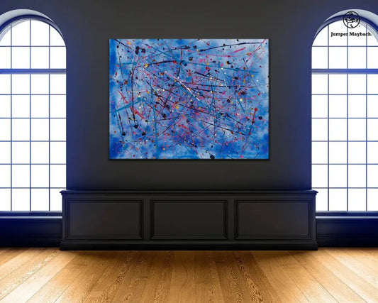 Luxurious living room with a large abstract blue painting, green sofa, and decorative items.