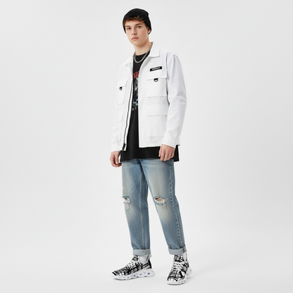 Person wearing a white jacket, black shirt, and ripped jeans on a light gray background