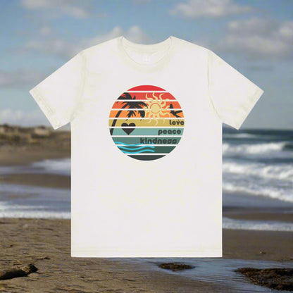 White t-shirt with a colorful graphic on a beach