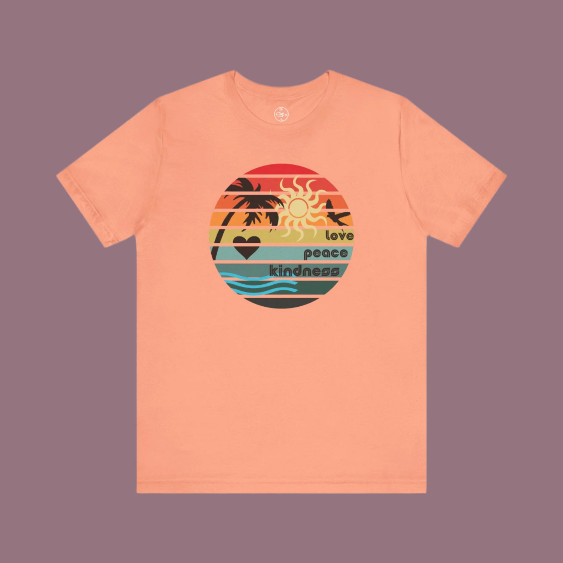 Peach-colored t-shirt with a colorful graphic design on a white background
