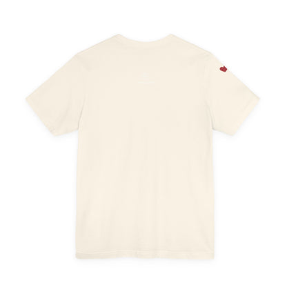 Beige t-shirt with a small red heart on the back against a white background